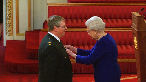 Dave Bull receives his QAM from the Queen